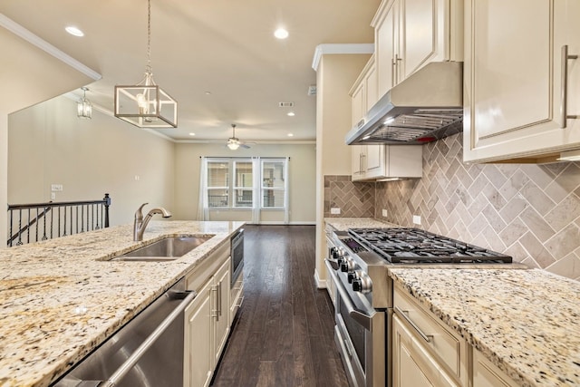 kitchen featuring sink, appliances with stainless steel finishes, extractor fan, light stone countertops, and decorative light fixtures