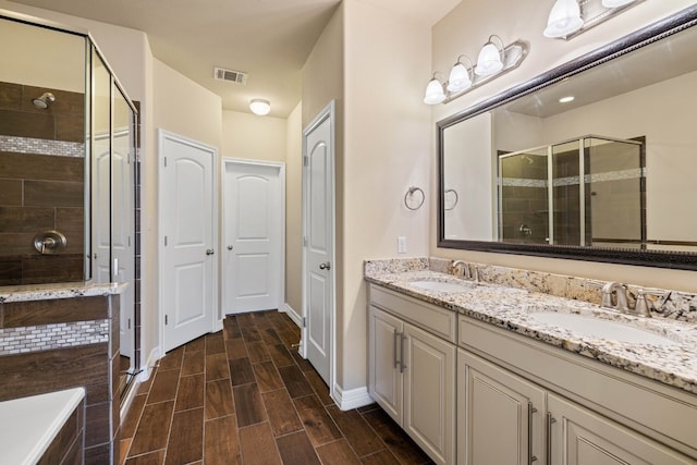 bathroom featuring walk in shower and vanity