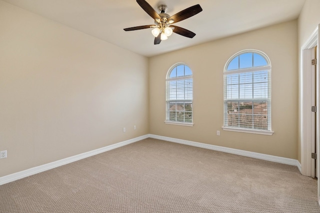 unfurnished room with ceiling fan and light carpet