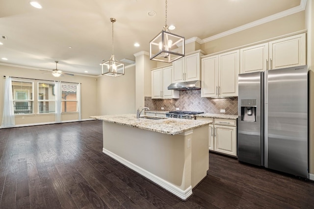 kitchen featuring stainless steel fridge, range, a kitchen island with sink, hanging light fixtures, and light stone counters