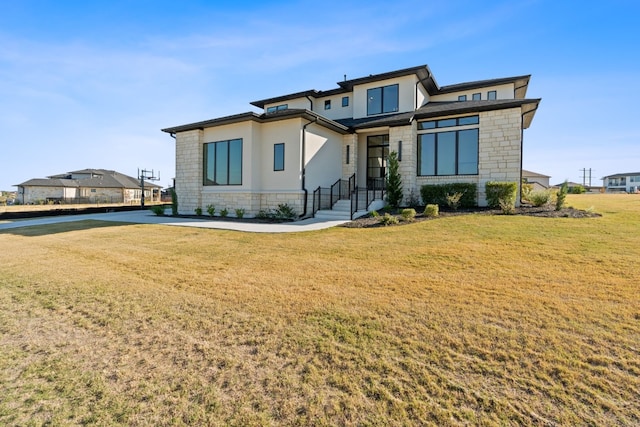 prairie-style house featuring a front lawn