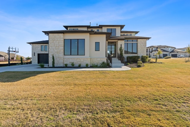 view of front of property featuring a garage and a front lawn