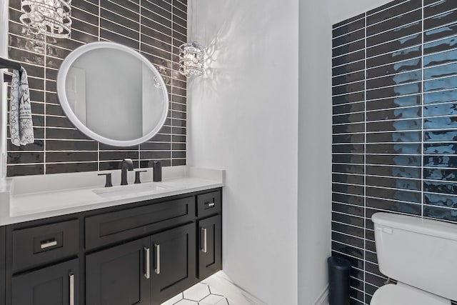 bathroom featuring vanity, decorative backsplash, tile walls, and toilet