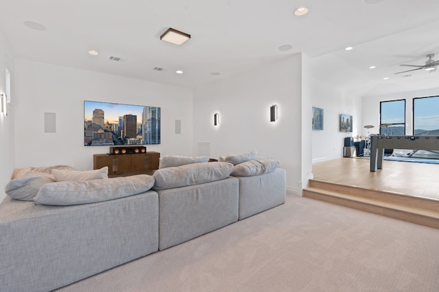 carpeted living room with ceiling fan