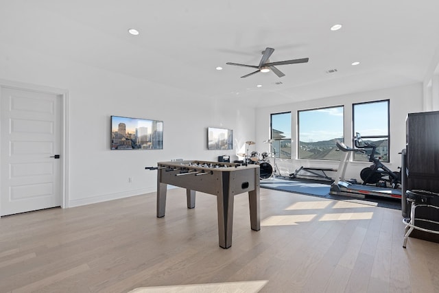 playroom with ceiling fan and light wood-type flooring