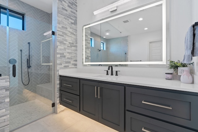 bathroom with tile patterned flooring, vanity, and a shower with shower door