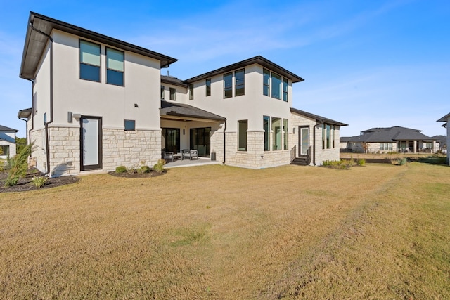 rear view of house featuring a patio and a lawn