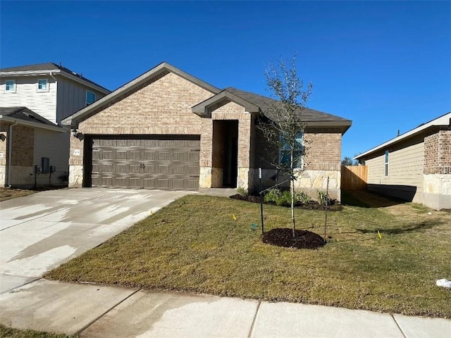 view of front of property featuring a garage and a front lawn