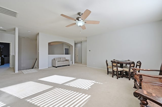 12304 Aralia Ridge Dr, Austin, TX 78739 - living area featuring light colored carpet, arched walkways, a ceiling fan, and baseboards