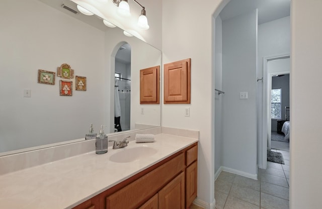 bathroom with tile patterned flooring and vanity