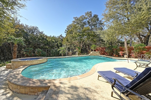 view of swimming pool with a patio area and an in ground hot tub