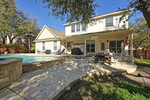 back of house featuring a fenced in pool and a patio