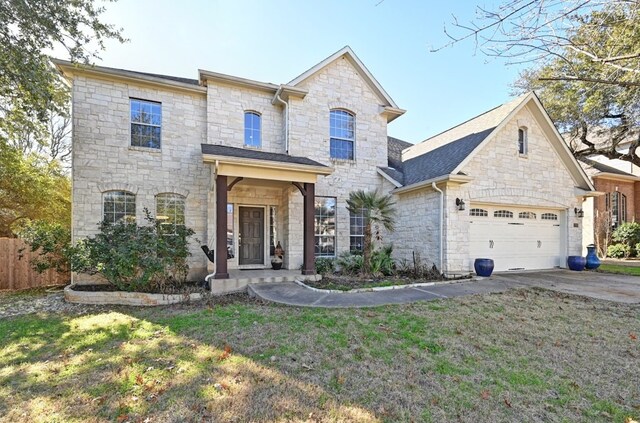 12304 Aralia Ridge Dr, Austin, TX 78739 - french provincial home with stone siding, driveway, an attached garage, and a front lawn