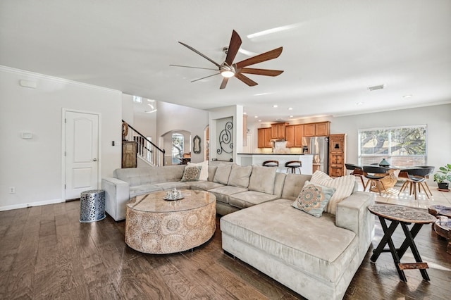 12304 Aralia Ridge Dr, Austin, TX 78739 - living area with arched walkways, a ceiling fan, dark wood-style floors, stairs, and crown molding