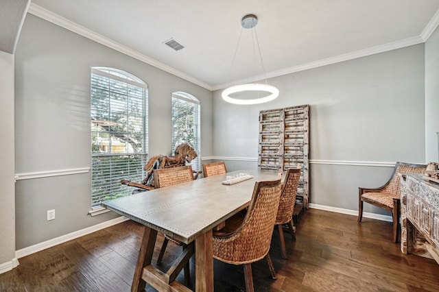 dining area featuring crown molding and dark hardwood / wood-style floors