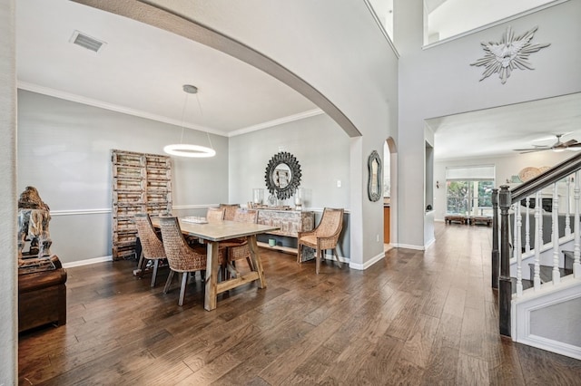 dining space featuring ceiling fan, ornamental molding, and dark hardwood / wood-style floors