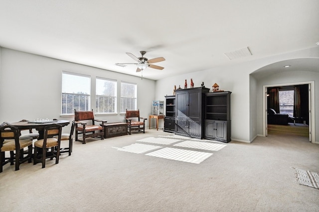 living room with ceiling fan and light carpet