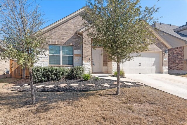 view of front of home with a garage and a front lawn