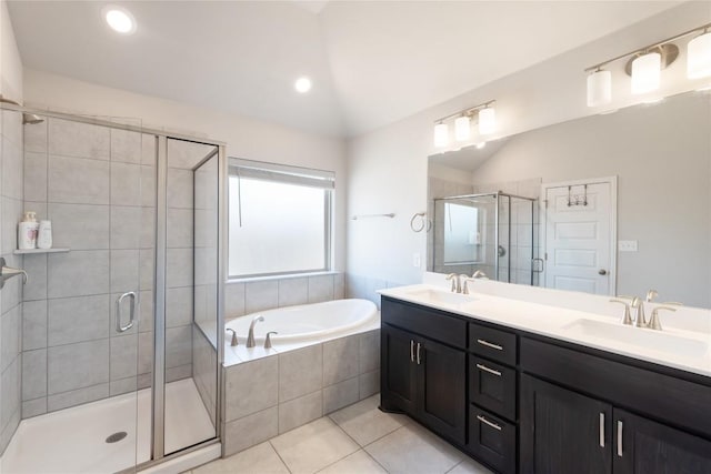 bathroom with tile patterned flooring, vanity, lofted ceiling, and independent shower and bath