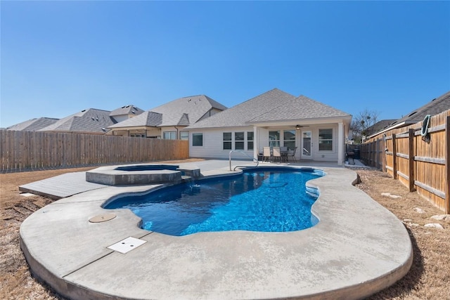 view of swimming pool with an in ground hot tub, ceiling fan, and a patio area