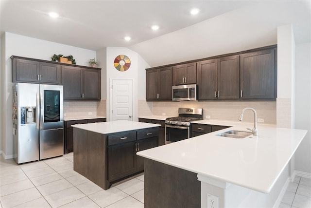 kitchen with sink, dark brown cabinets, stainless steel appliances, and a center island