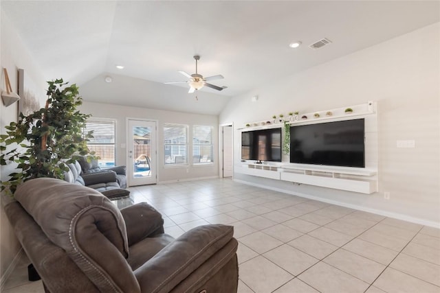 living room featuring lofted ceiling, ceiling fan, and light tile patterned flooring