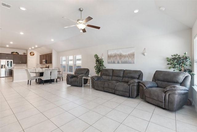 tiled living room featuring vaulted ceiling and ceiling fan