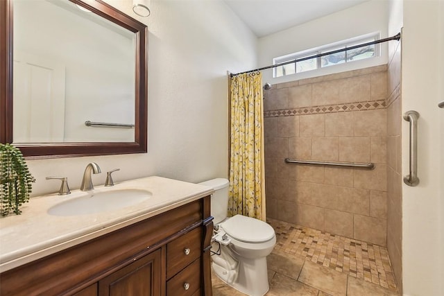 bathroom with tile patterned flooring, vanity, toilet, and a shower with curtain