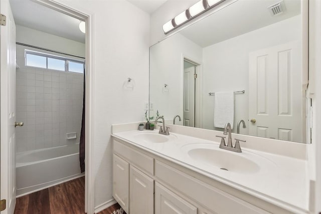 bathroom featuring shower / tub combo, vanity, and hardwood / wood-style floors