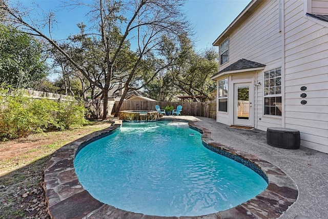 view of swimming pool with pool water feature and a patio