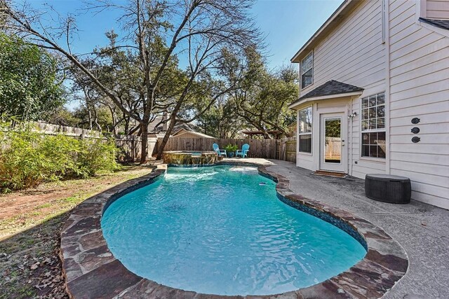 view of pool featuring a patio area, a fenced in pool, a fenced backyard, and an outdoor hot tub