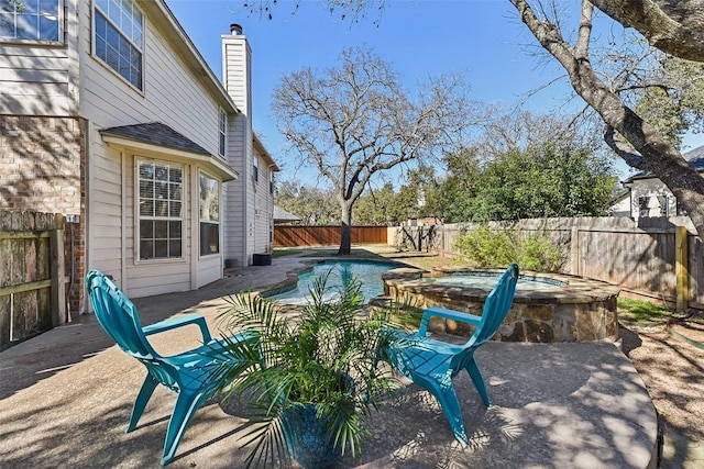 view of patio / terrace with a pool with hot tub