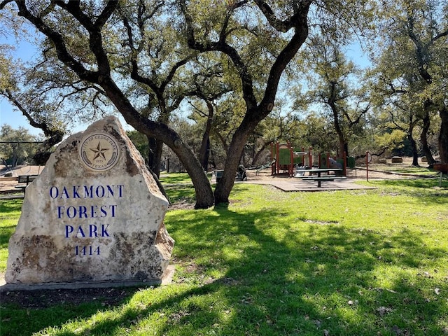 view of home's community with a lawn and a playground