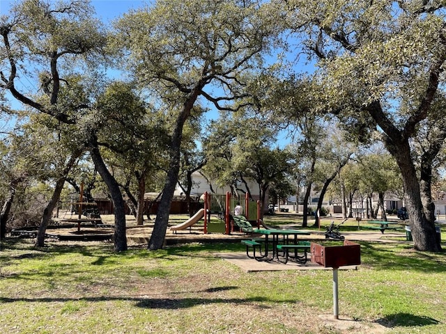 view of community featuring playground community and a yard