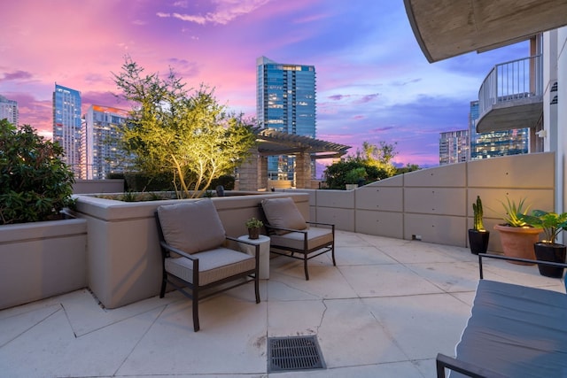 360 Nueces St Unit 914, Austin, TX 78701 - patio terrace at dusk featuring a city view, a patio, and an outdoor living space