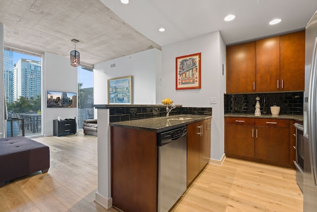 360 Nueces St Unit 914, Austin, TX 78701 - kitchen with appliances with stainless steel finishes, a peninsula, light wood finished floors, backsplash, and floor to ceiling windows