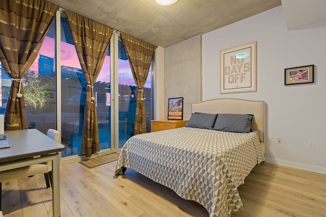 360 Nueces St Unit 914, Austin, TX 78701 - bedroom with wood-type flooring, access to exterior, and baseboards