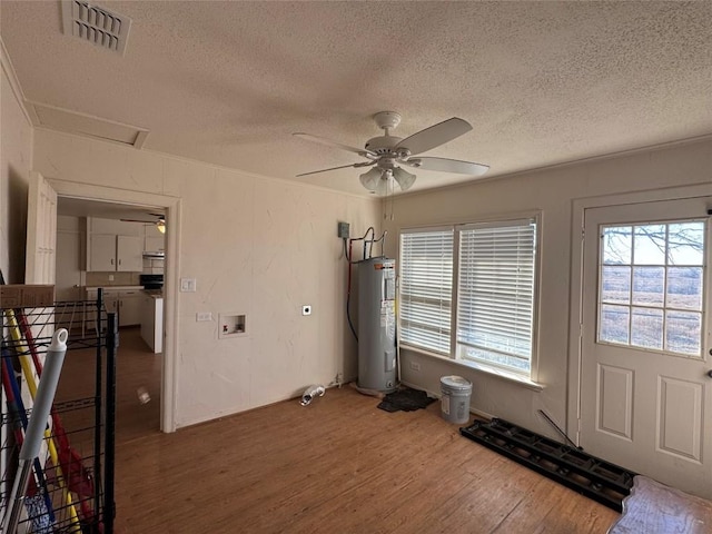 interior space with water heater, dark wood-type flooring, a textured ceiling, and ceiling fan