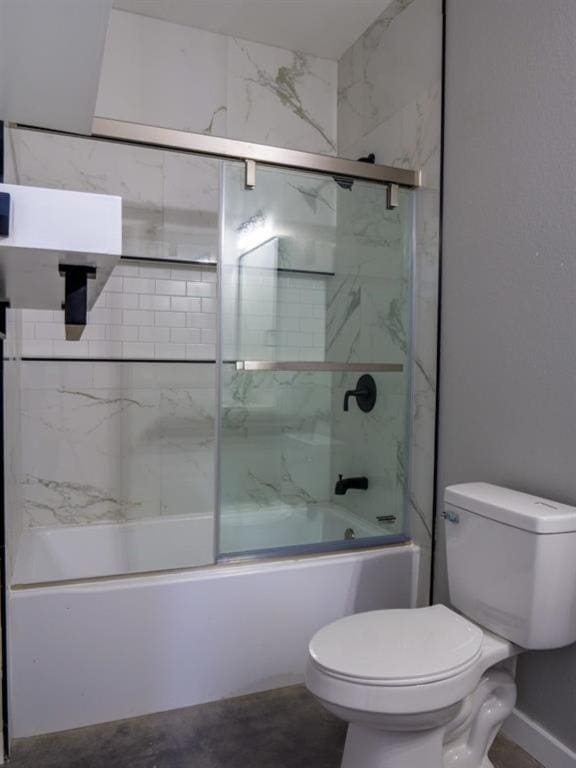 bathroom featuring shower / bath combination with glass door and toilet