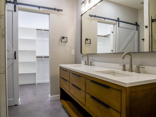 bathroom featuring vanity and concrete flooring