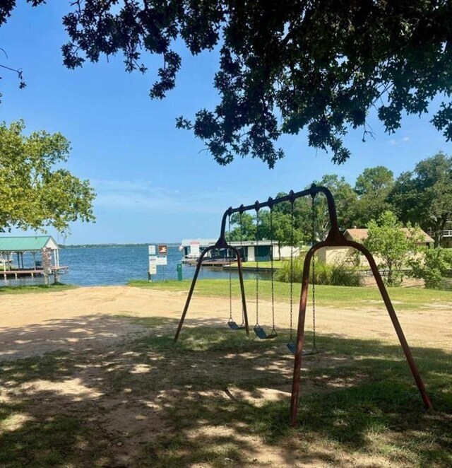 view of jungle gym with a water view