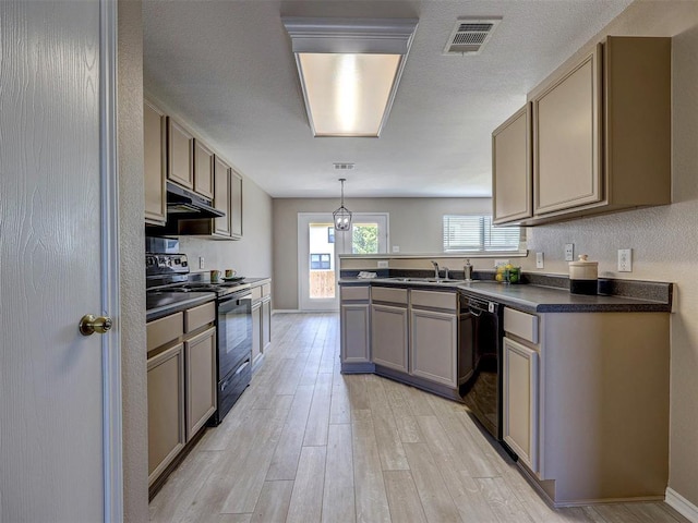 kitchen featuring sink, hanging light fixtures, black appliances, kitchen peninsula, and light wood-type flooring