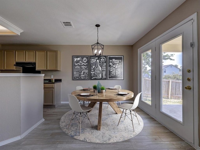 dining space featuring an inviting chandelier and light hardwood / wood-style floors