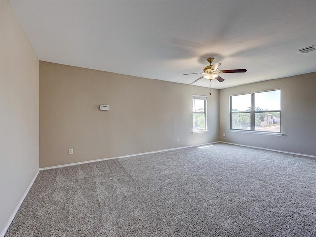 spare room featuring carpet flooring and ceiling fan