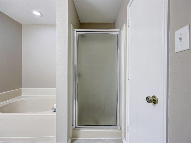 bathroom with separate shower and tub