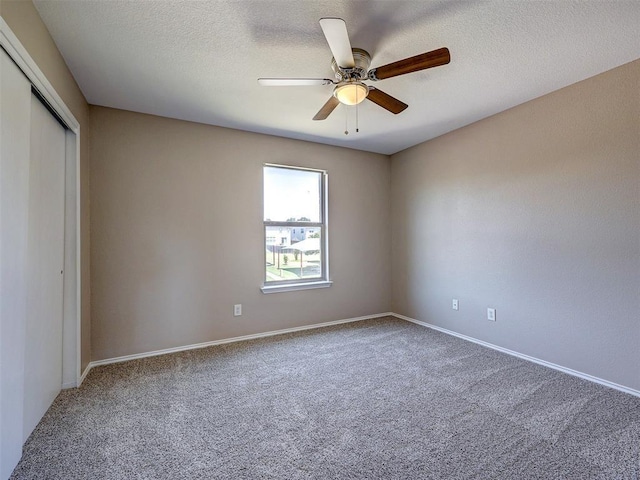 interior space with ceiling fan and a textured ceiling