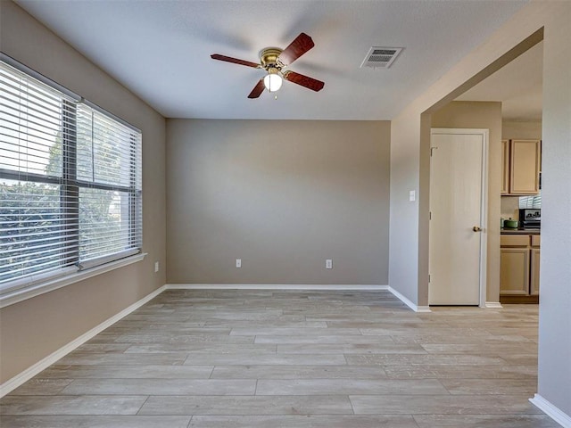 unfurnished room with ceiling fan and light wood-type flooring