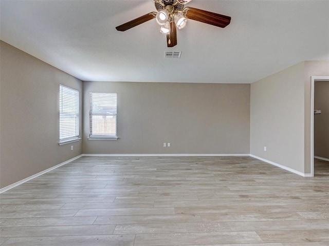 empty room with ceiling fan and light hardwood / wood-style flooring