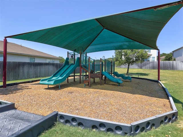 view of jungle gym featuring a lawn