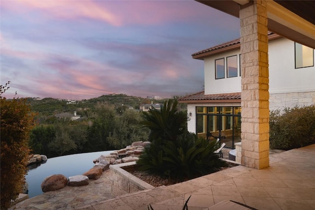 view of patio terrace at dusk